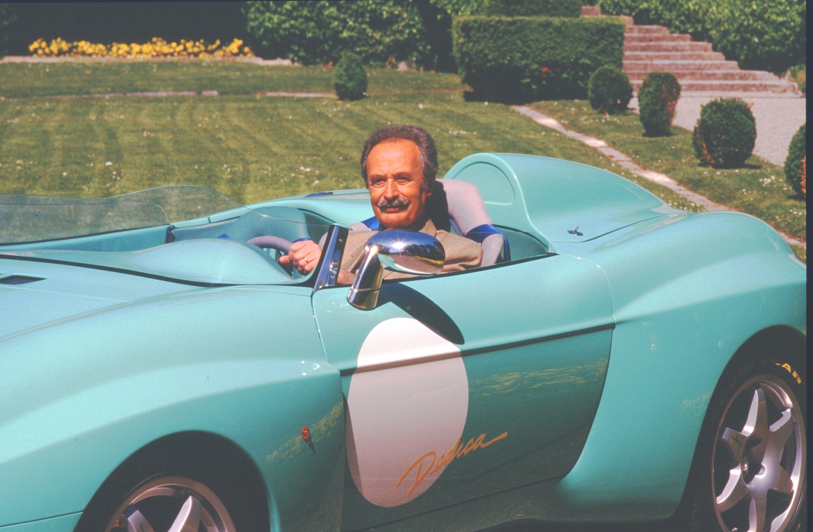 Aldo Brovarone at the wheel of the turquoise Stola Dedica